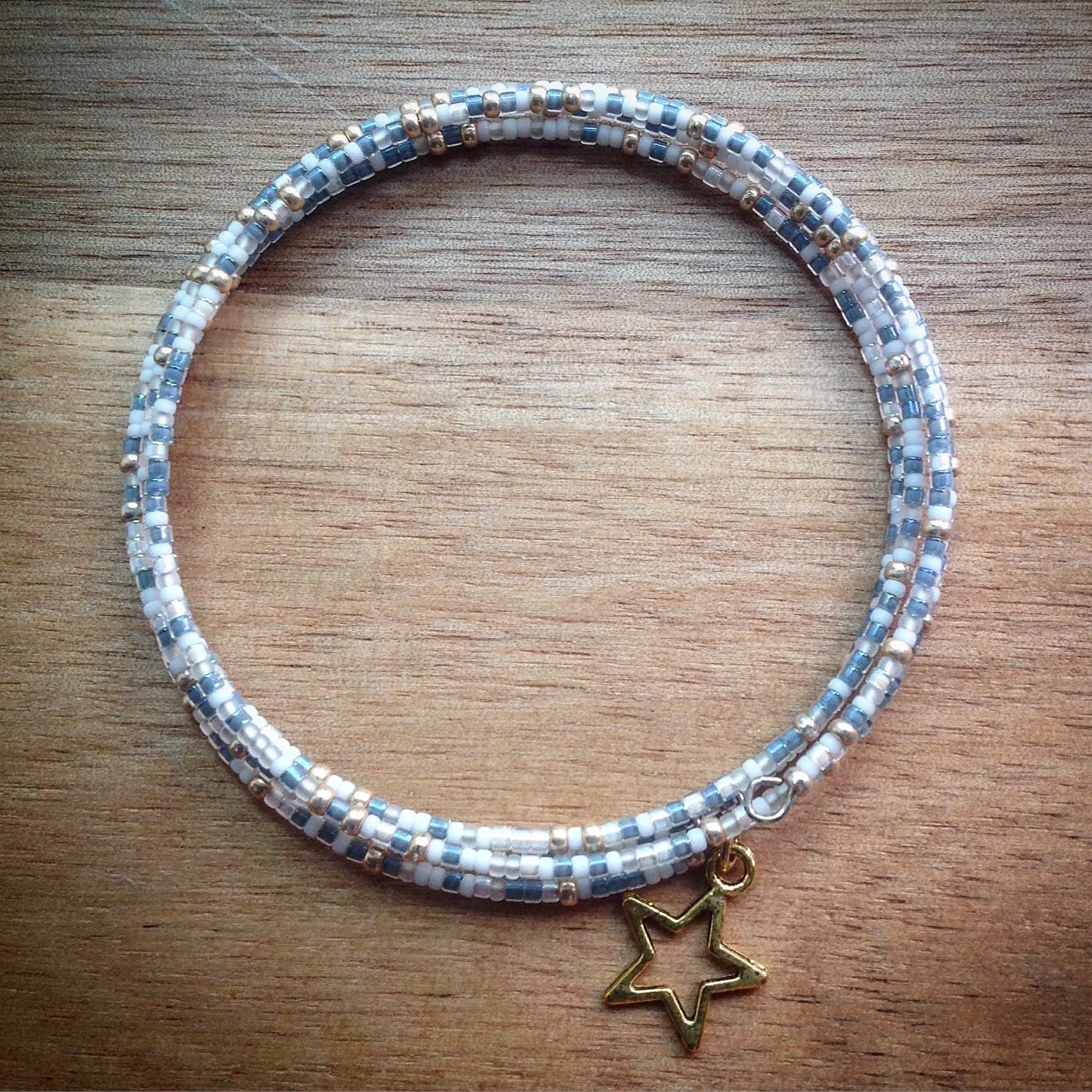 Beaded memory wire bracelet - white, gold and blue/grey seed beads and gold star pendant