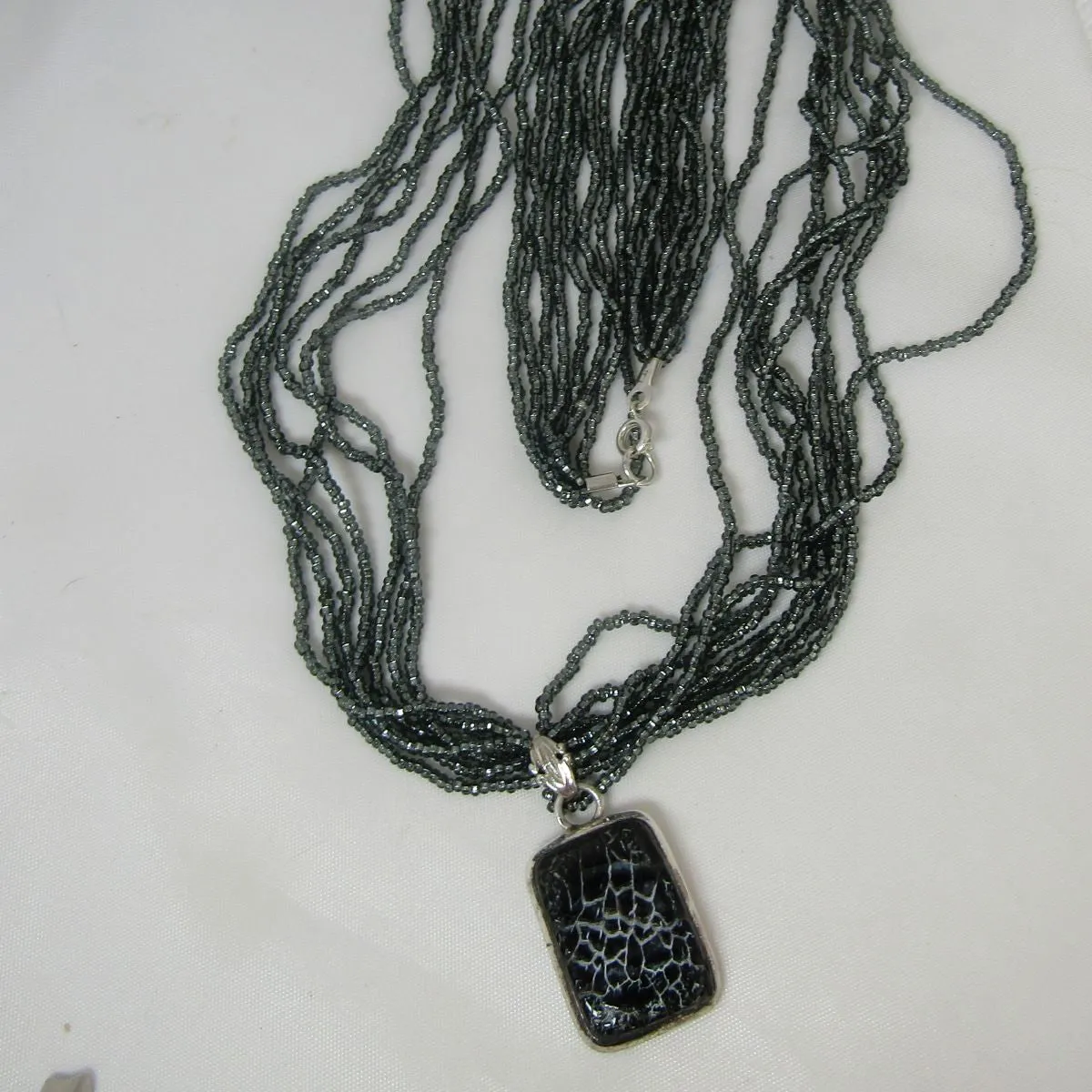 Charcoal Multi-strand Necklace with Dinosaur Bone Pendant